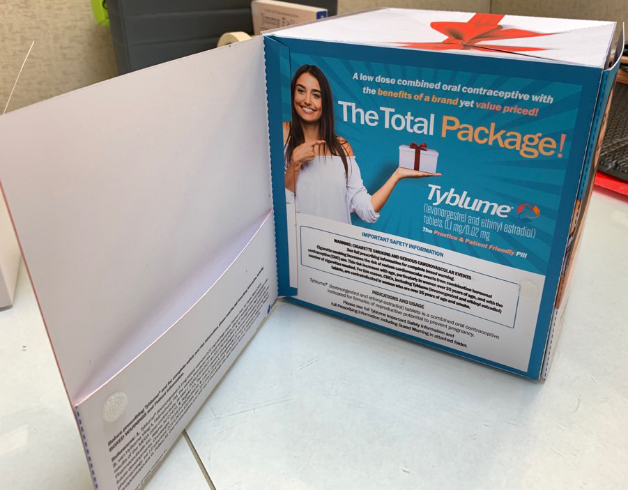 Photo of Tyblume® levonorgestrel and ethinyl estradiol tablets, a combined oral contraceptive indicated for females of reproductive potential to prevent pregnancy, 3-dimensional visual aid on a desk open to the first page which reads THE TOTAL PACKAGE.